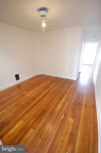 2218 Annapolis Road Baltimore, MD 21230 - Photo 9 of 15 a view of empty room with wooden floor