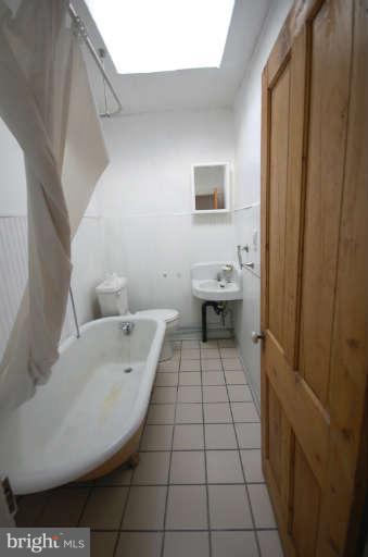 2218 Annapolis Road Baltimore, MD 21230 - Photo 10 of 15 a bathroom with a sink a toilet and a bathtub
