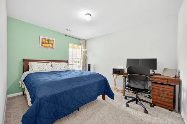 a bedroom with a bed and a desk