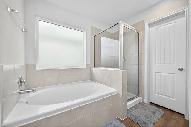 a white bath tub sitting next to a shower