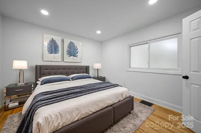 a bedroom with a bed and lamps