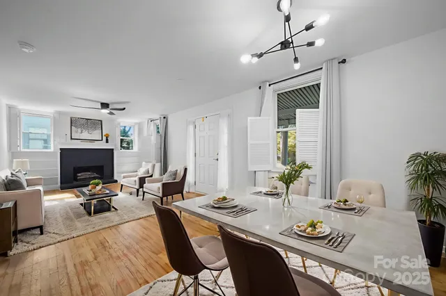 a living room with furniture kitchen view and a fireplace