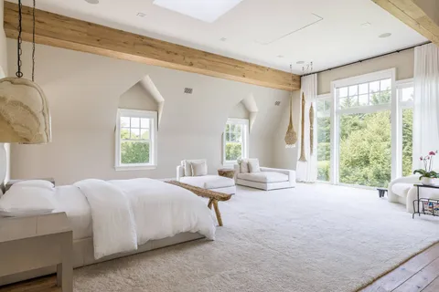 a bedroom with a bed and windows