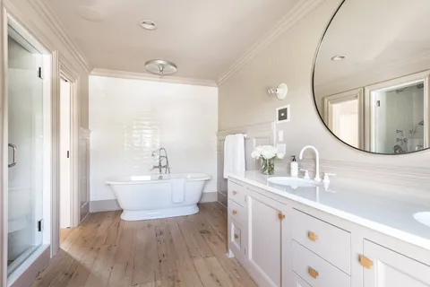 a bathroom with a sink mirror and a toilet