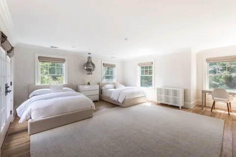 a spacious bedroom with two beds and a couch