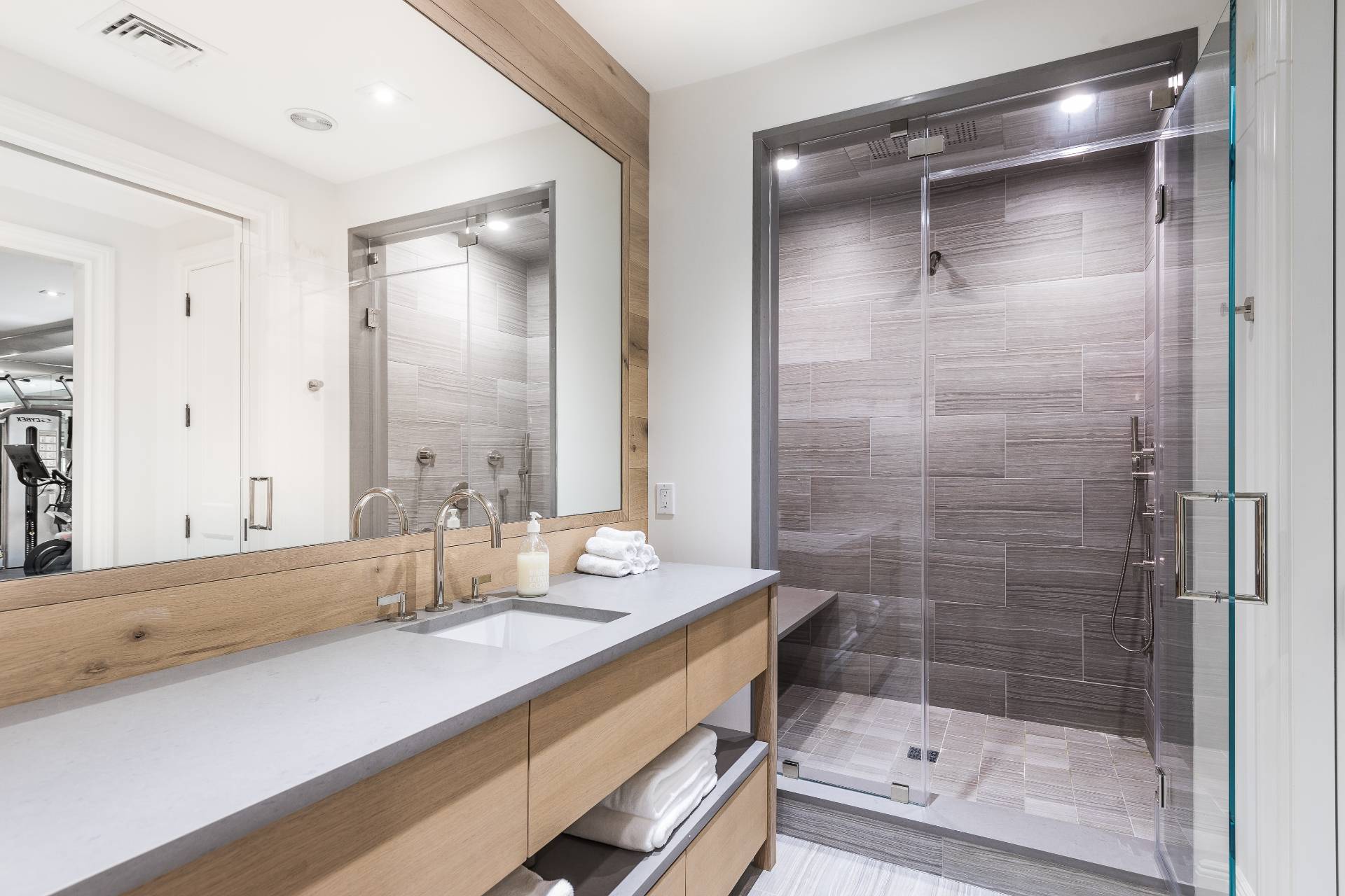 373 Mitchell Lane Bridgehampton, NY 11932 - Photo 25 of 34 a bathroom with a shower sink and mirror