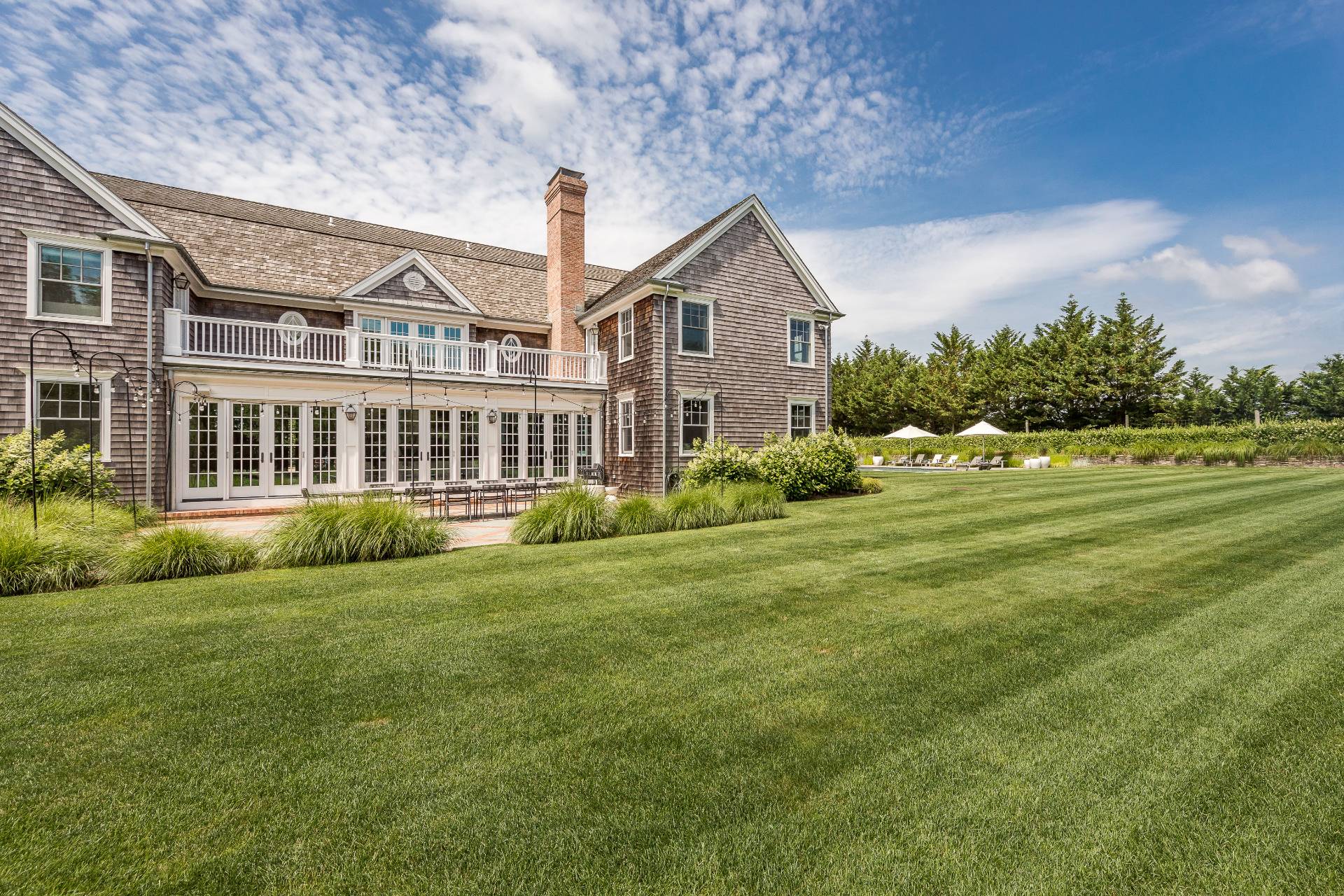 373 Mitchell Lane Bridgehampton, NY 11932 - Photo 29 of 34 a front view of a house with a yard