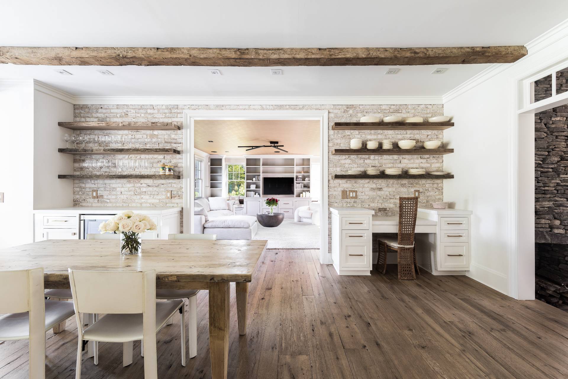 373 Mitchell Lane Bridgehampton, NY 11932 - Photo 6 of 31 a dining room with furniture a fireplace and wooden floor