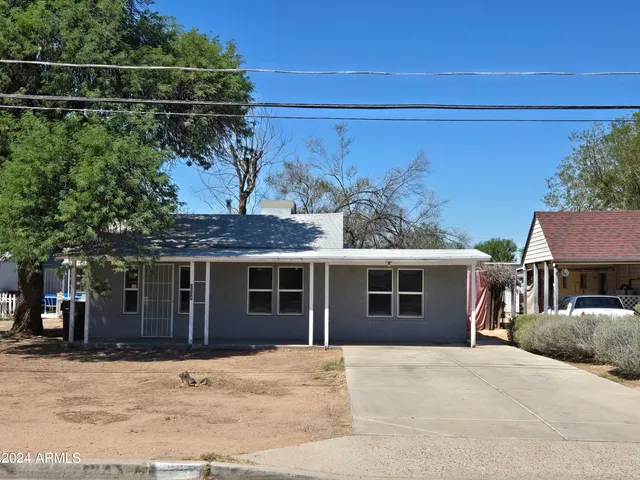 a front view of a house with a garden and garage