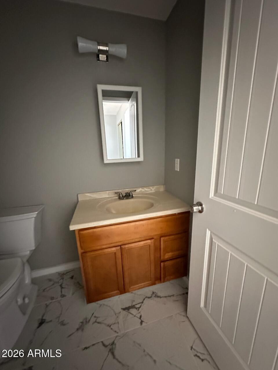 2632 North 29th Place, Unit 2 Phoenix, AZ 85008 - Photo 4 of 6 a bathroom with a sink a toilet and a mirror