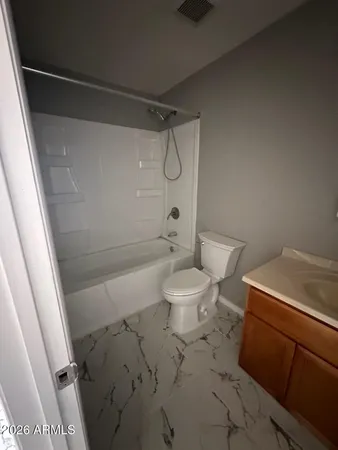a bathroom with a toilet sink and shower