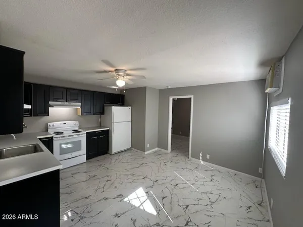 a large white kitchen with refrigerator stove and oven