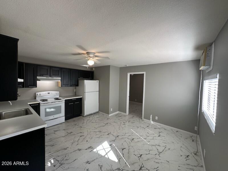 2632 North 29th Place, Unit 2 Phoenix, AZ 85008 - Photo 6 of 6 a large white kitchen with refrigerator stove and oven