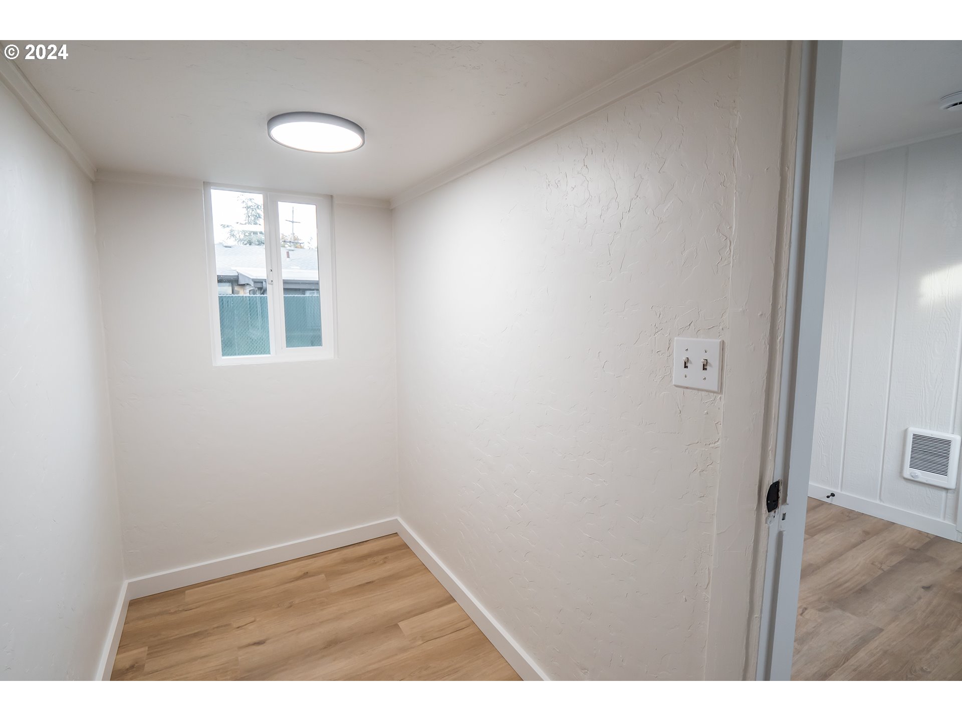 1022 Mill Street Springfield, OR 97477 - Photo 23 of 32 a view of an empty room with wooden floor and a window