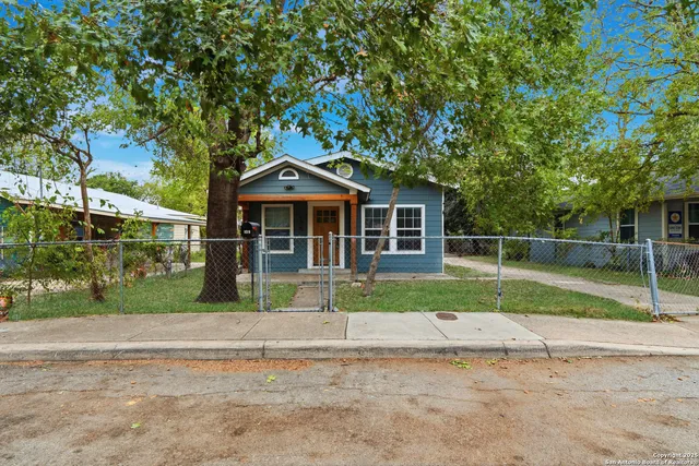 a house with green field in front of it