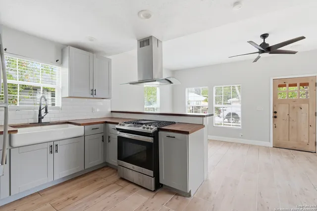 a kitchen with stainless steel appliances granite countertop a stove and a sink