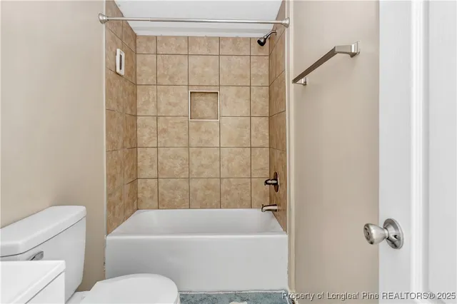 a bathroom with a toilet and a bathtub