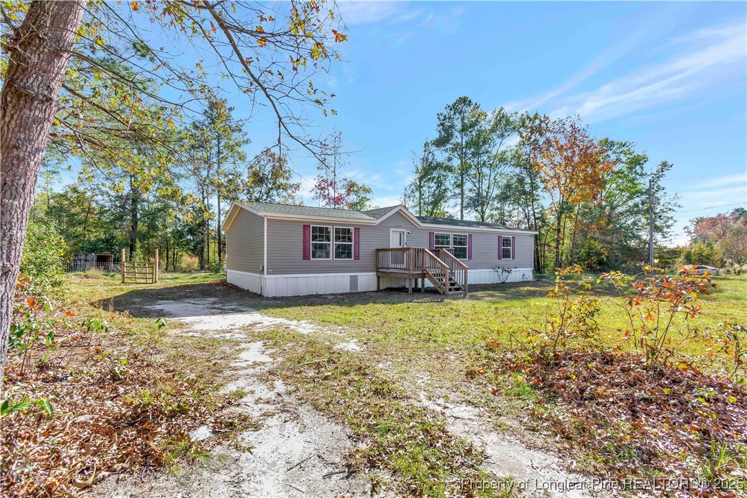 157 Amarilla Road Fairmont, NC 28340 - Photo 2 of 24 a backyard of a house with yard and outdoor seating