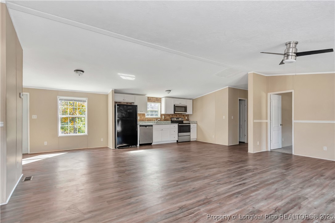 157 Amarilla Road Fairmont, NC 28340 - Photo 5 of 24 a view of an empty room with window and wooden floor
