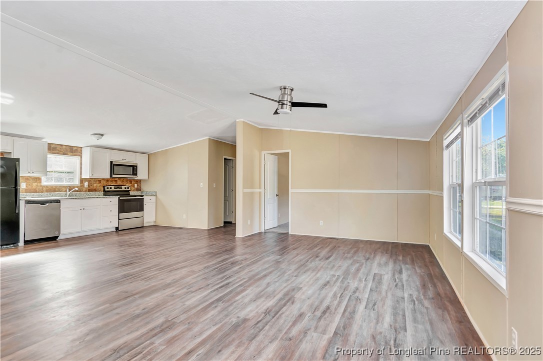 157 Amarilla Road Fairmont, NC 28340 - Photo 6 of 24 a view of a kitchen with wooden floor and a window