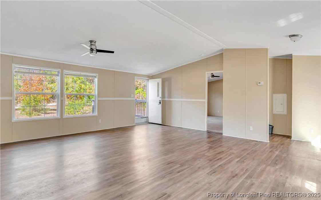 157 Amarilla Road Fairmont, NC 28340 - Photo 8 of 24 an empty room with wooden floor cabinet and windows