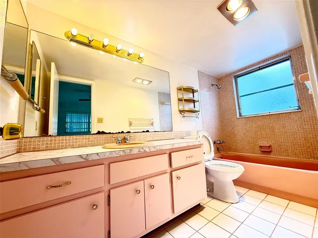 a bathroom with a sink a toilet and bathtub