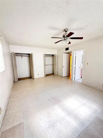 a view of empty room with ceiling fan