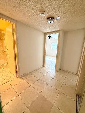 a view of a livingroom with an empty space and a window