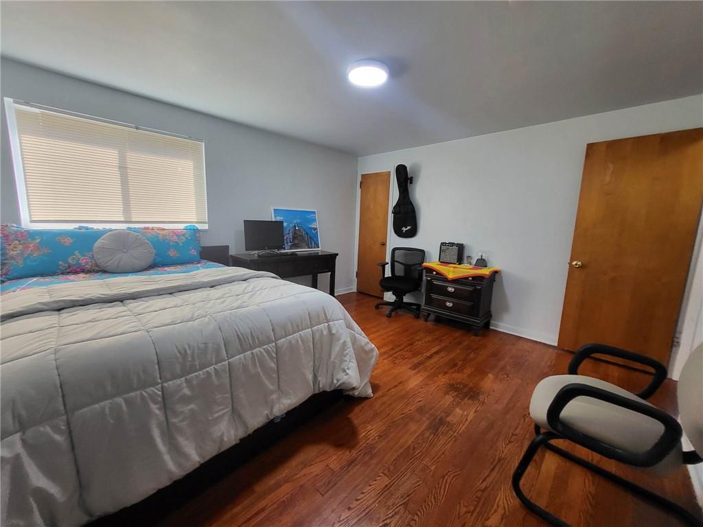 225 Greenlee Road Pittsburgh, PA 15227 - Photo 14 of 24 a bedroom with a bed and wooden floor