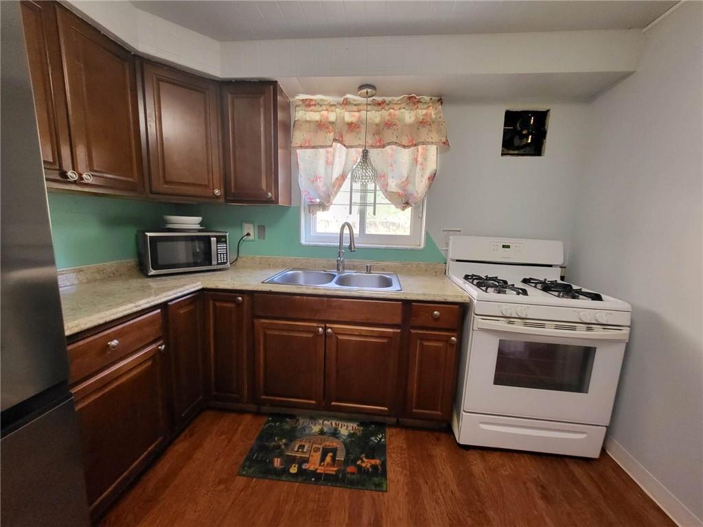 225 Greenlee Road Pittsburgh, PA 15227 - Photo 7 of 24 a kitchen with stainless steel appliances a stove a sink and a microwave