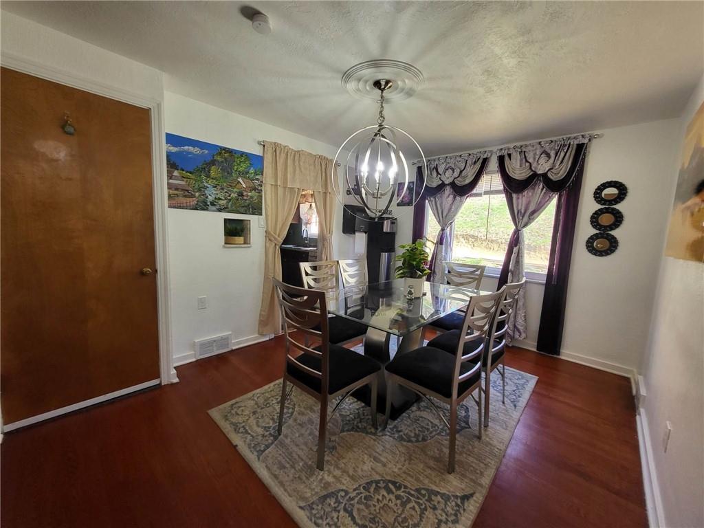 225 Greenlee Road Pittsburgh, PA 15227 - Photo 8 of 24 a dining room with furniture a chandelier and wooden floor