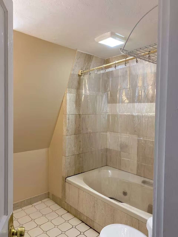12 Baldwin Street, Unit 1 Newton, MA 02458 - Photo 3 of 7 a bathroom with a bathtub