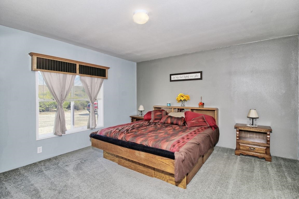1831 10 Road Mack, CO 81525 - Photo 15 of 27 a bedroom with a bed and a window