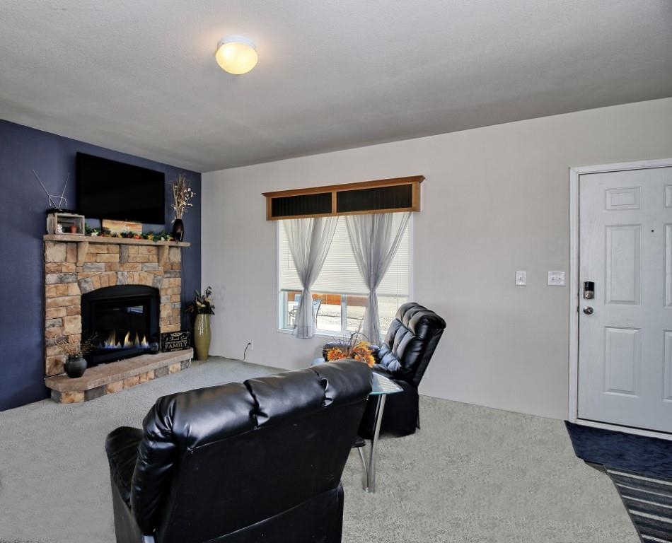 1831 10 Road Mack, CO 81525 - Photo 3 of 27 a living room with furniture a window and a fireplace