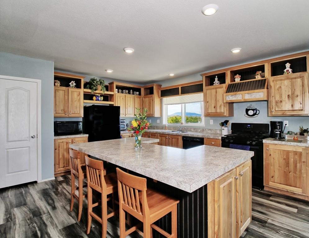 1831 10 Road Mack, CO 81525 - Photo 7 of 27 a kitchen with stainless steel appliances granite countertop a kitchen island a stove a sink a refrigerator and cabinets