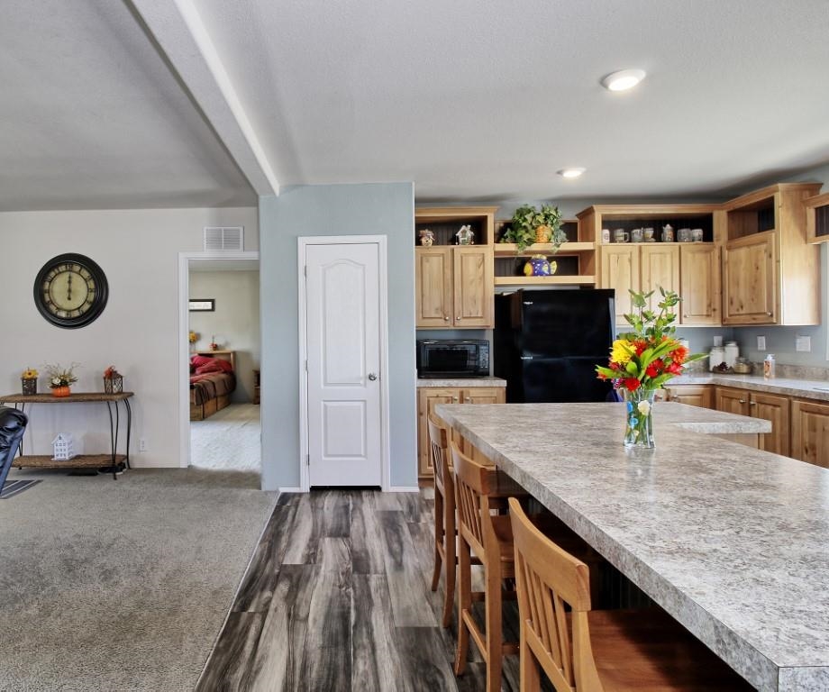 1831 10 Road Mack, CO 81525 - Photo 10 of 27 a kitchen with granite countertop a stove a sink and a refrigerator
