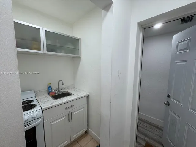 a bathroom with a sink and cabinets