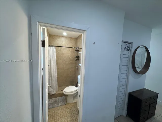 a bathroom with a toilet a sink and shower