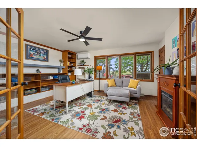 a dining room with furniture a chandelier and window