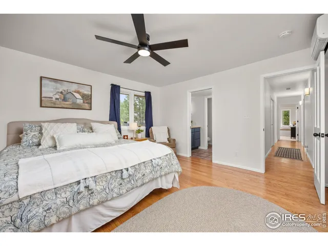 a spacious bedroom with a bed and a window