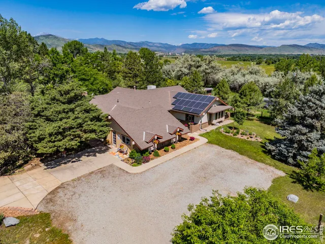 a front view of a house with a fountain