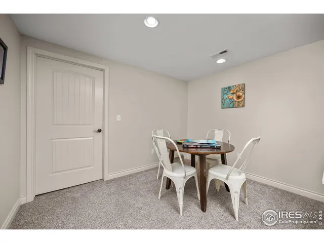 a view of a room with a bed and wooden floor