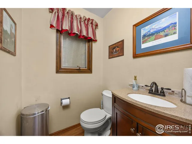 a living room with furniture a table and kitchen view