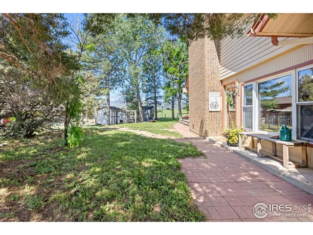 a front view of house with a garden and patio