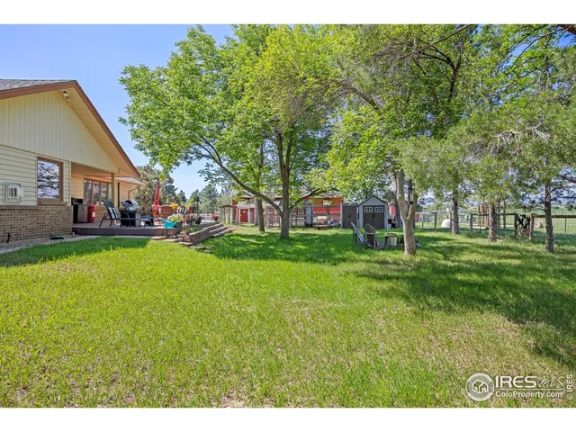 a view of a house with backyard and a sitting area