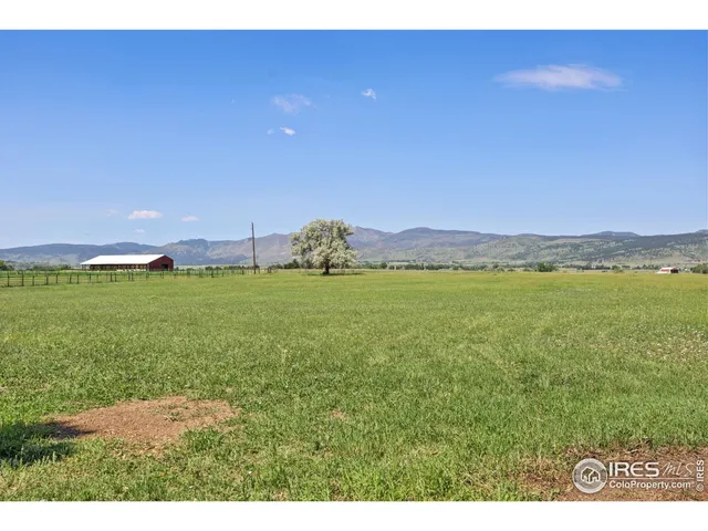 an aerial view of a residential houses with outdoor space