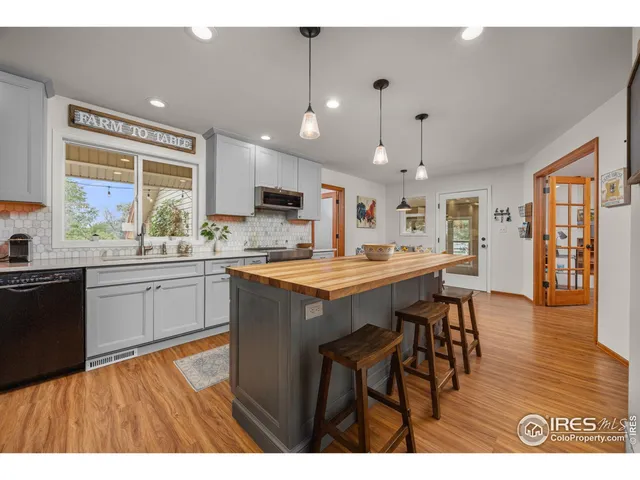 a large kitchen with stainless steel appliances kitchen island granite countertop a large counter top and a stove