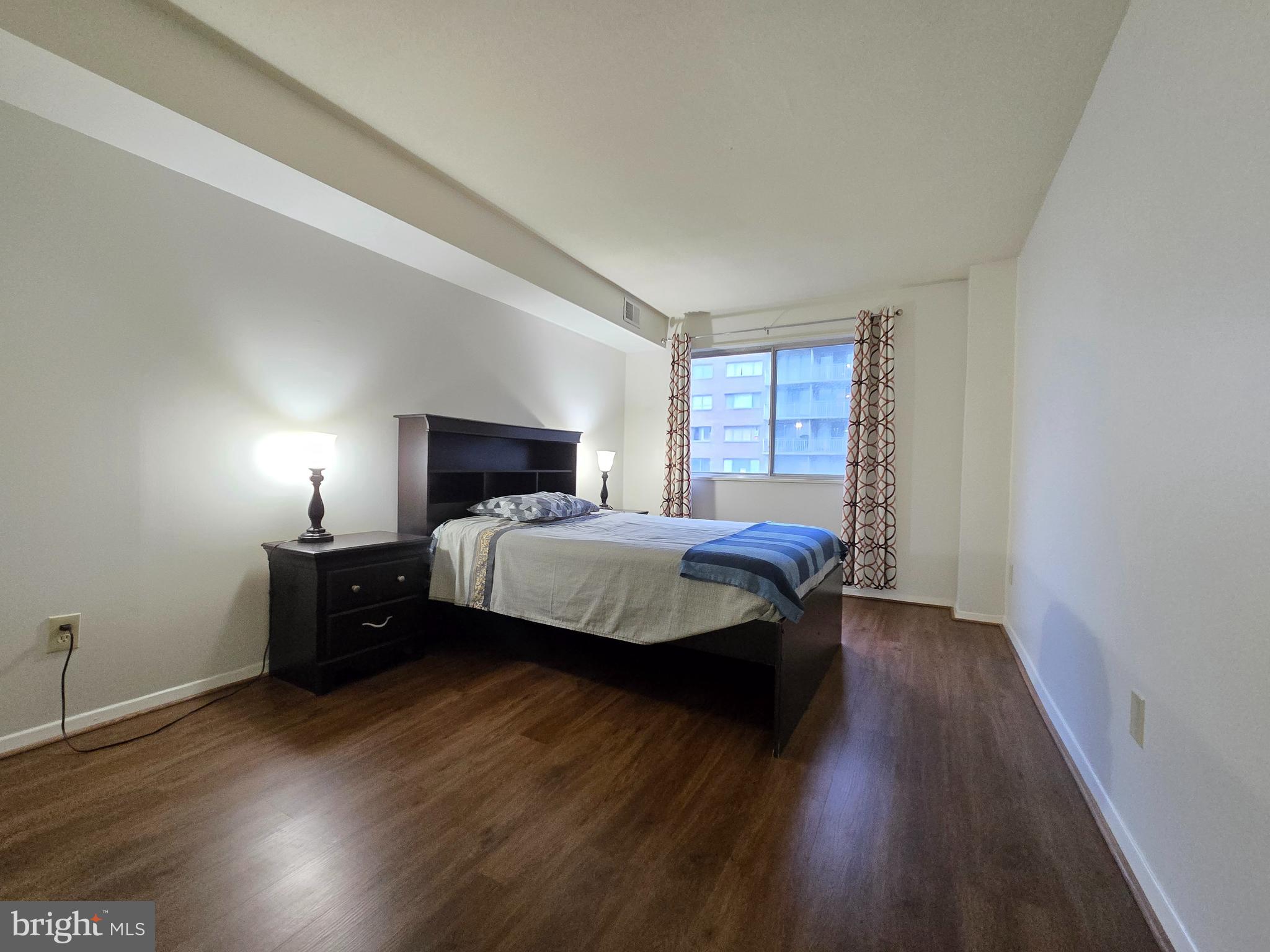 1836 Metzerott Road, Unit 1524 Hyattsville, MD 20783 - Photo 18 of 22 a bedroom with a bed and wooden floor