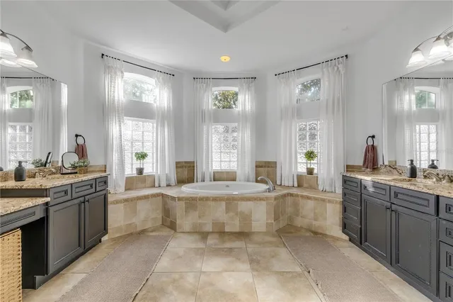 a kitchen with stainless steel appliances granite countertop a sink dishwasher stove top oven and refrigerator with wooden floor