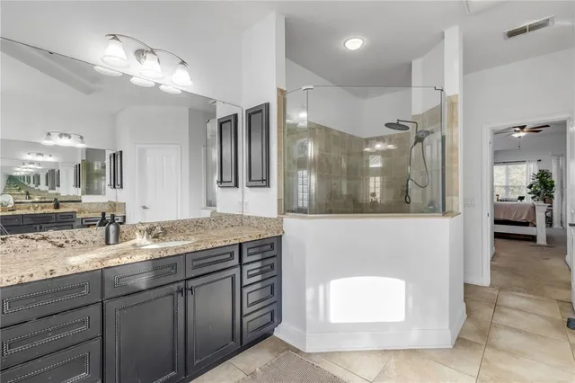 a kitchen with kitchen island granite countertop stainless steel appliances and wooden cabinets